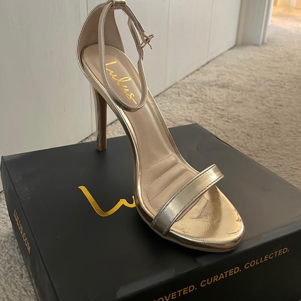 Gold strappy high heels.